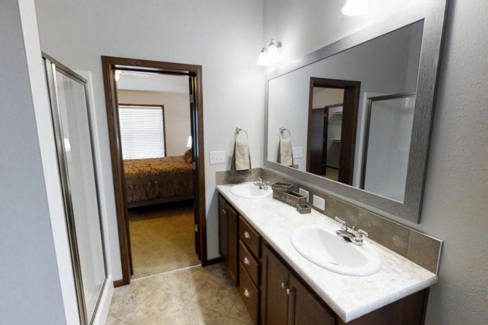 Tiled bathroom with double vanity in a modular home